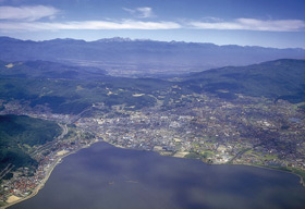 諏訪湖上空より岡谷市を望む